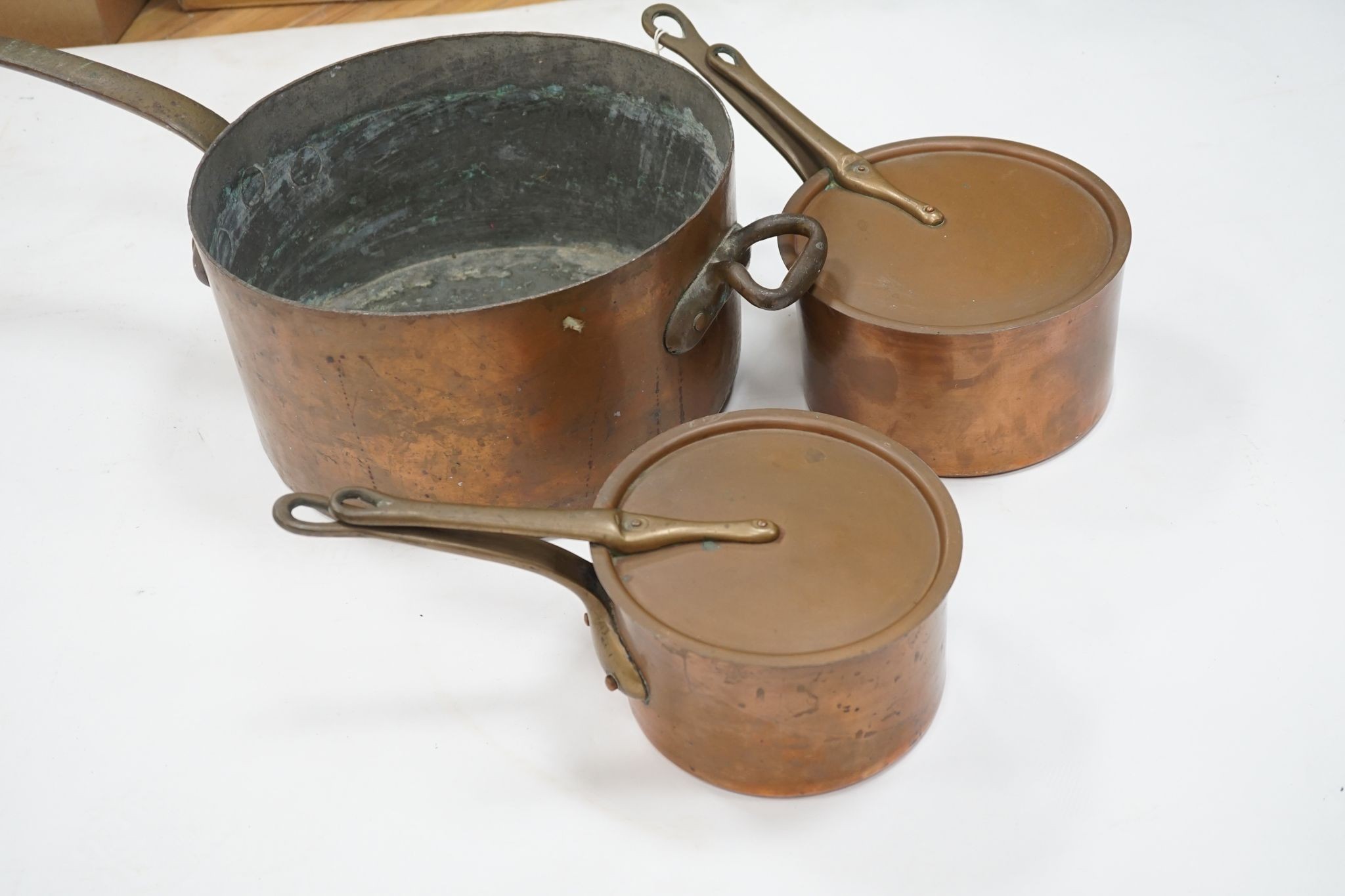 A group of three Jaeggi & Sons copper saucepans